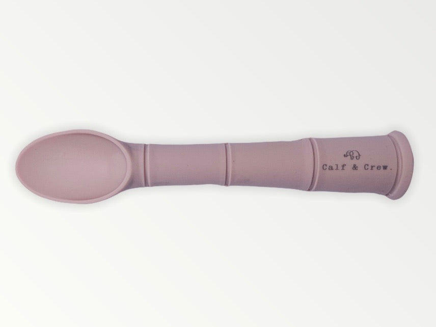 a my first baby spoon in rose silicone with the calf & crew logo